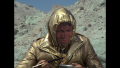 Maj. Duke Danton attempting to eat a cooked animal while in survival gear on Vistula (BR25: "Planet of the Slave Girls").
