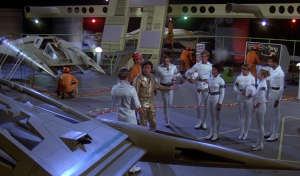 Dr. Elias Huer presents the only active pilots available for the Battle of Vistula (BR25: "Planet of the Slave Girls").
